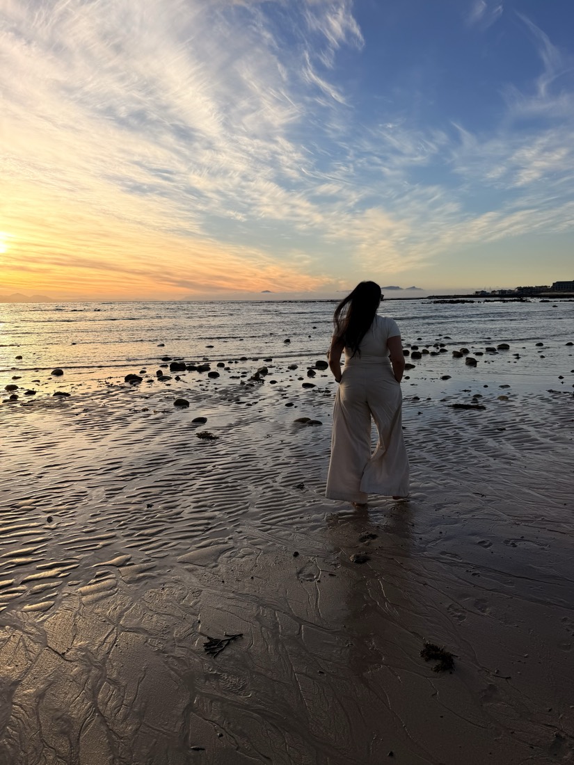 Teneille walking into the sea at sunset